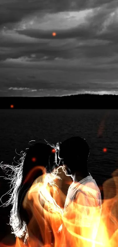 Romantic black and white couple silhouette by the water under a cloudy sky.