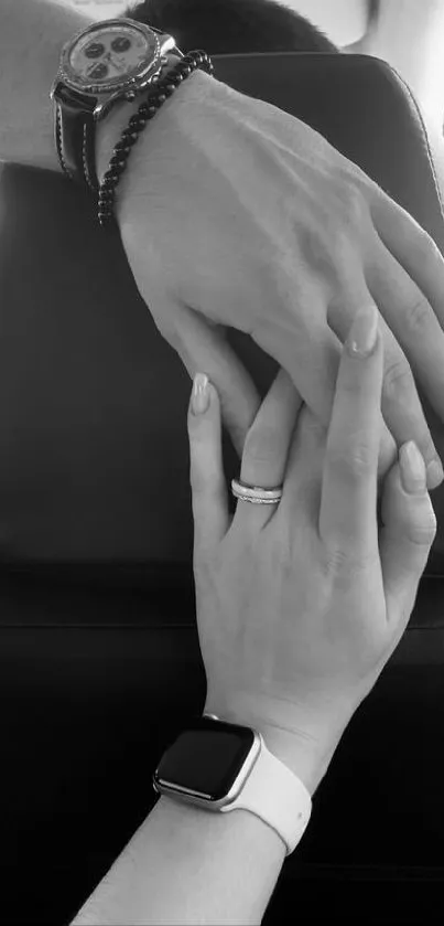 Two hands holding in black and white setting.