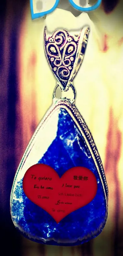 Blue pendant with multilingual love inscription and heart.