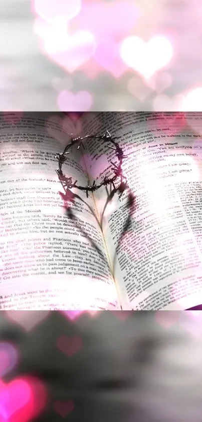 Open book with heart and pink bokeh light effects.