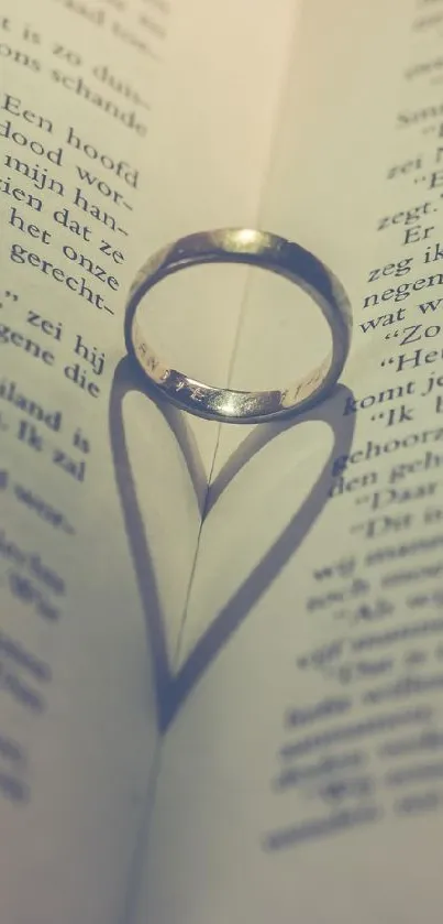 Ring shadow creates heart shape on open book, symbolizing love.