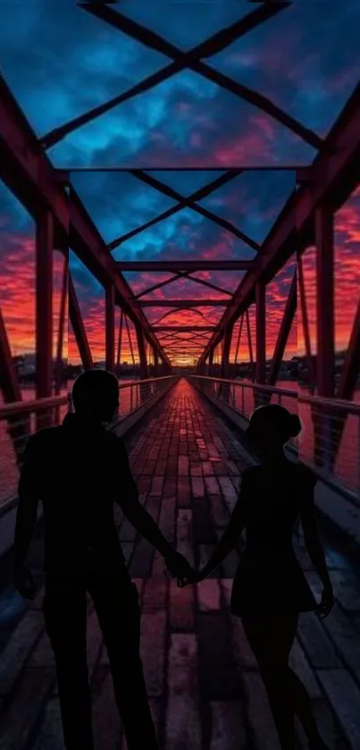 Silhouetted couple on bridge at sunset.