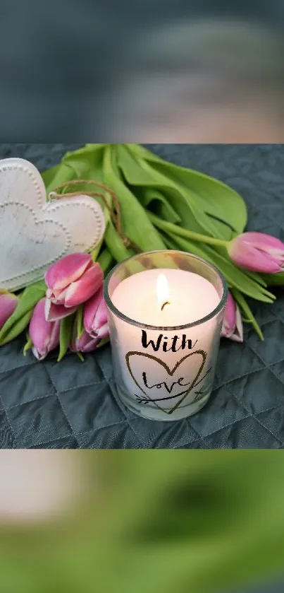 Candle with 'With Love' text surrounded by pink tulips and heart decor.