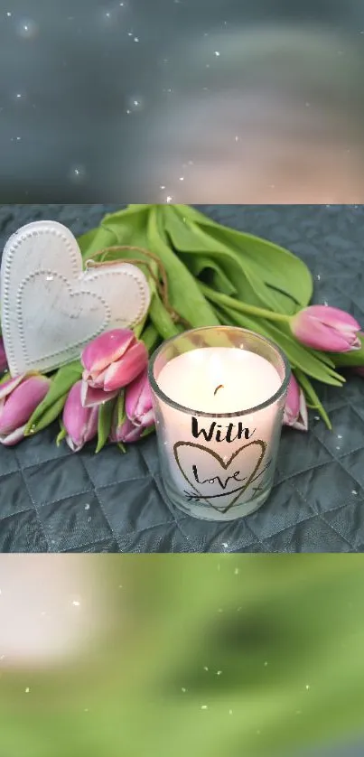 Candle with heart and pink tulips on a gray background.