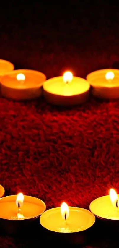 Heart-shaped candlelight on rich red texture.