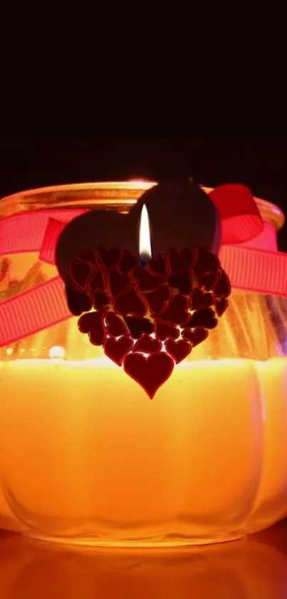 Romantic candle jar with a heart design glowing warmly.