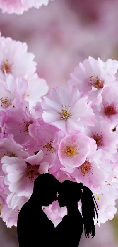 Enchanting cherry blossoms with silhouetted couple embracing.