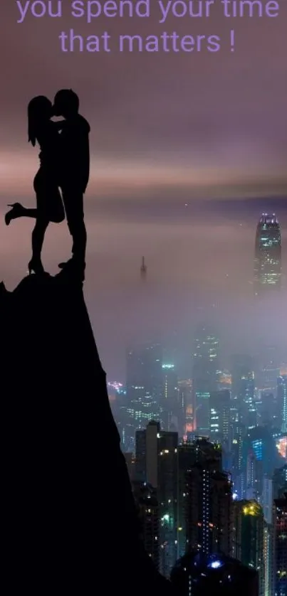 Silhouette of a couple kissing atop a cliff with a misty cityscape background.