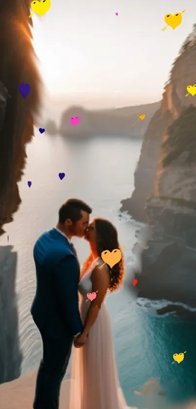 A couple embraces on a cliffside with heart shapes and stunning blue ocean.