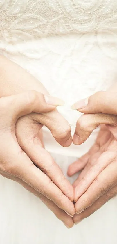 Couple forming heart shape with hands, symbolizing love and unity.