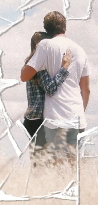 Couple embracing in a field with cracked glass overlay.