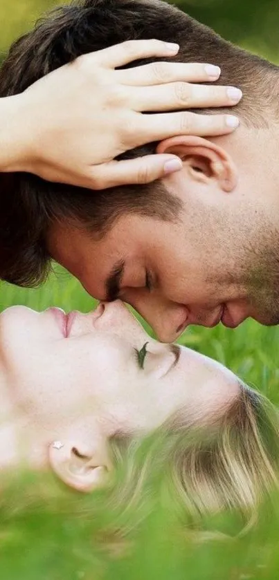 Romantic couple lying in green grass, embracing in nature.