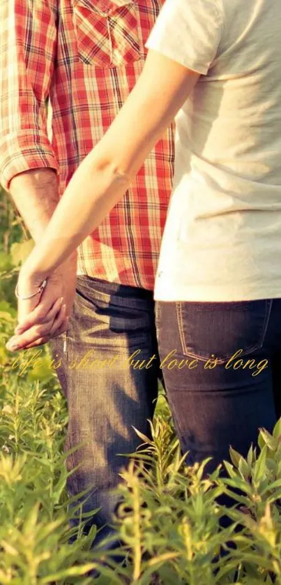 A couple holding hands in a verdant field under warm sunlight.