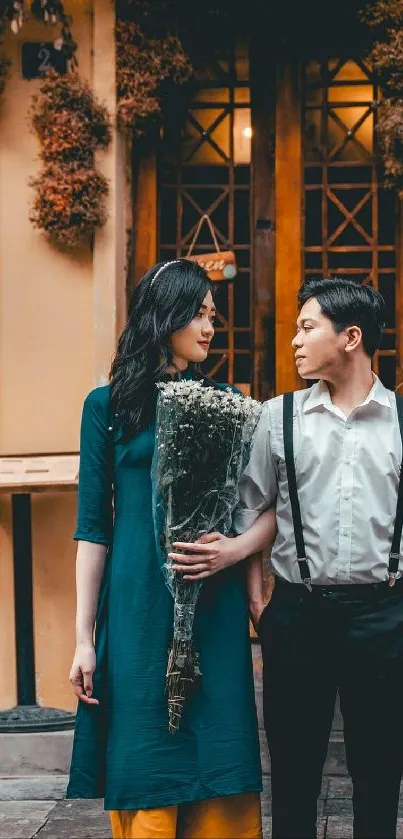 Romantic couple posing with bouquet in urban setting.