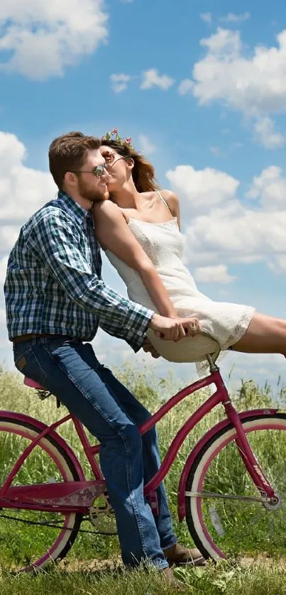 Couple on pink bicycle under blue sky with clouds.