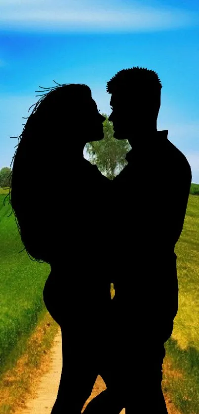 Romantic silhouette of a couple in nature with a blue sky background.