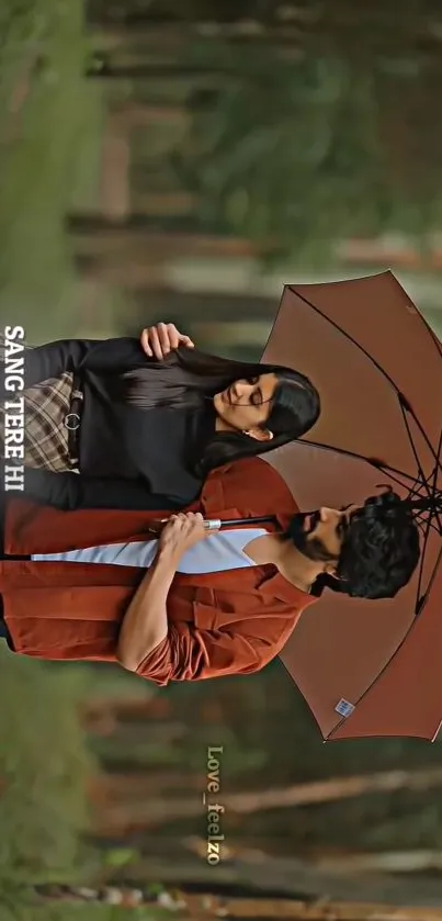 Romantic couple standing under umbrella in a forest setting.