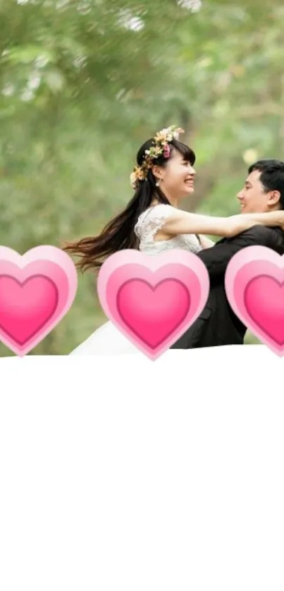 Romantic couple in nature with pink hearts on a mobile phone wallpaper.