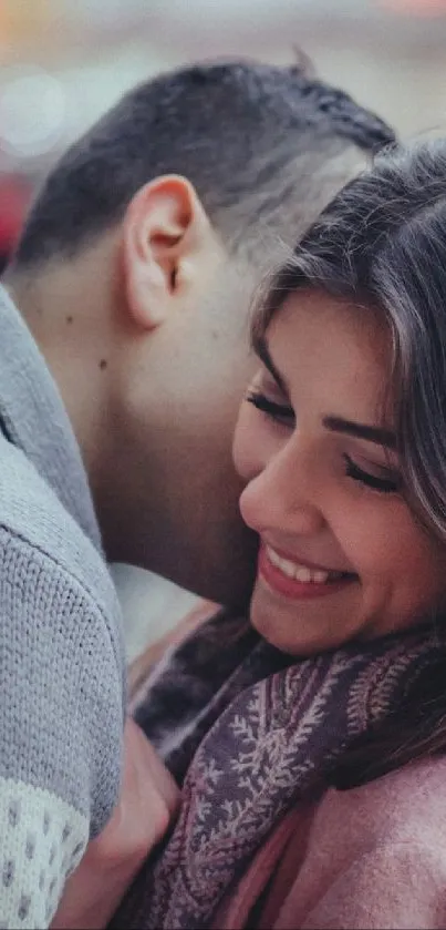 Couple embracing in winter with festive lights.