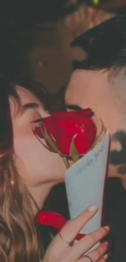 Romantic couple sharing a kiss behind a red rose.