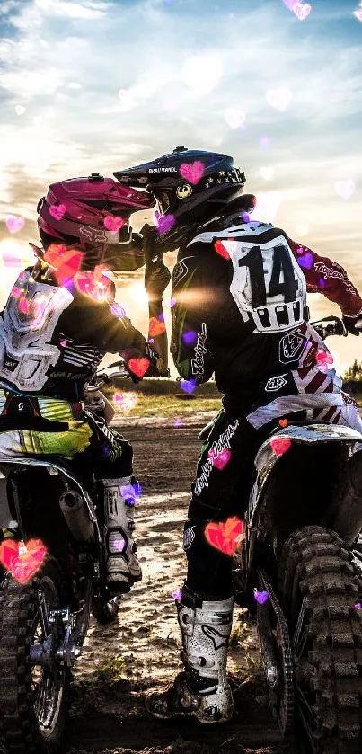 Couple on dirt bikes embraces as hearts fill the sunset sky.