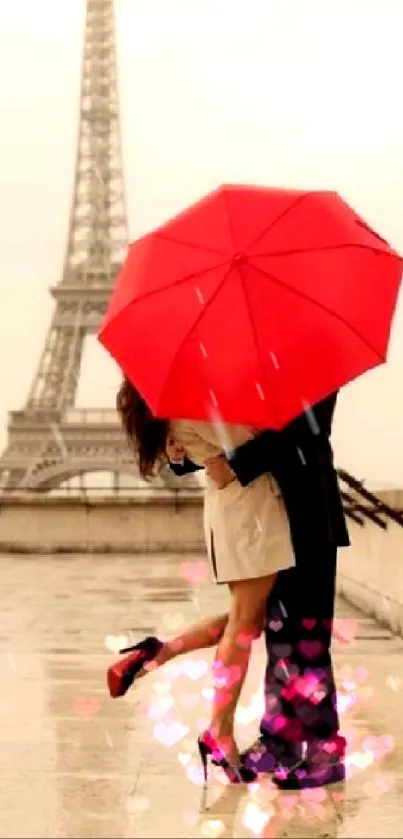 Couple in Paris kissing under a red umbrella by the Eiffel Tower.