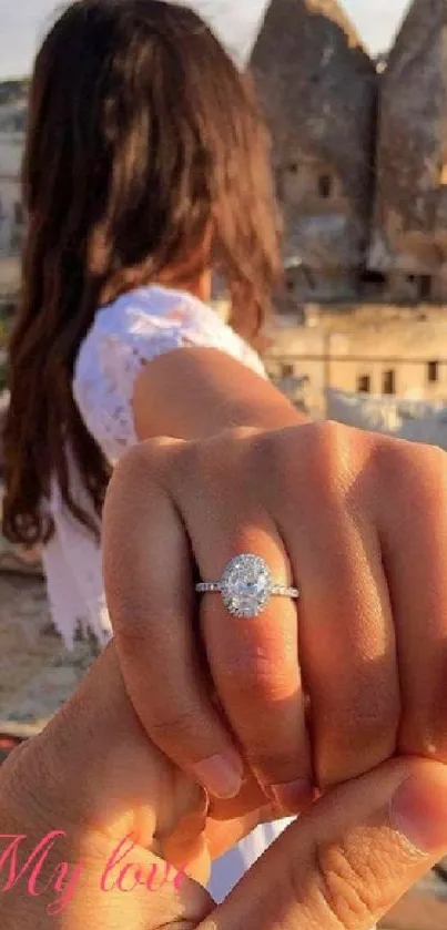 Couple holding hands with engagement ring and scenic view.