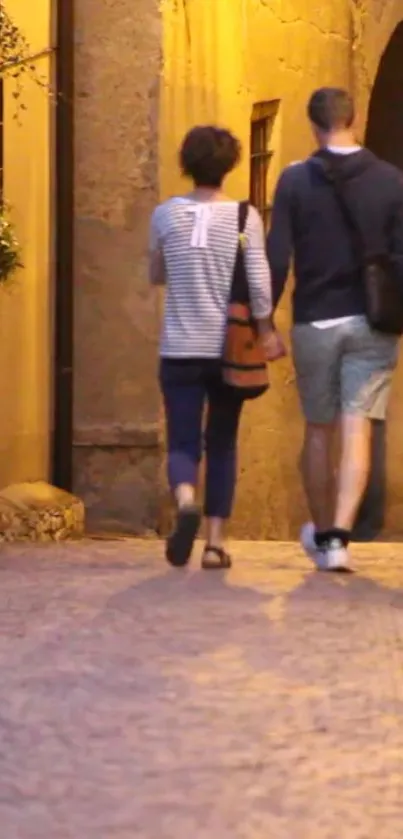 Couple walking through an evening-lit cobblestone street.