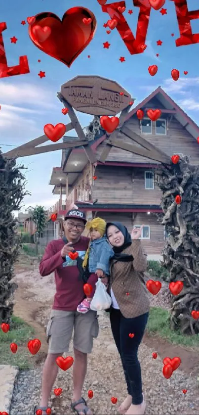 Family poses by rustic house under love sign.