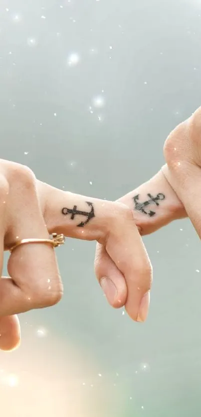 Couple's fingers with anchor tattoos gently touching in a romantic gesture.