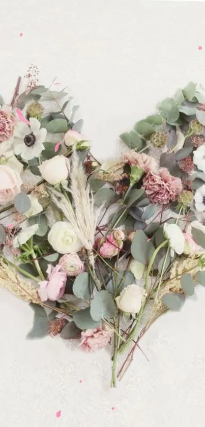 Heart-shaped floral design with pastel flowers and greenery.