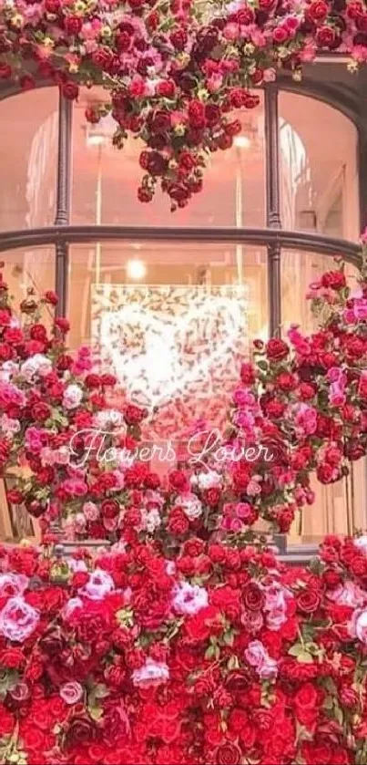 Heart-shaped floral arrangement in vibrant pink and red hues on a shop window display.