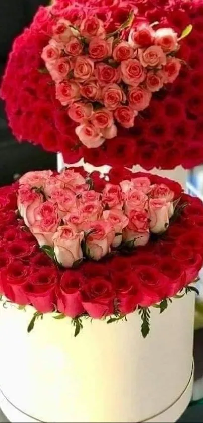 Beautiful heart-shaped rose arrangement with red and pink flowers.