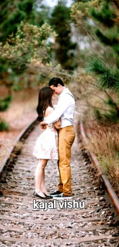 Couple embracing on a forest railway in a romantic mobile wallpaper.