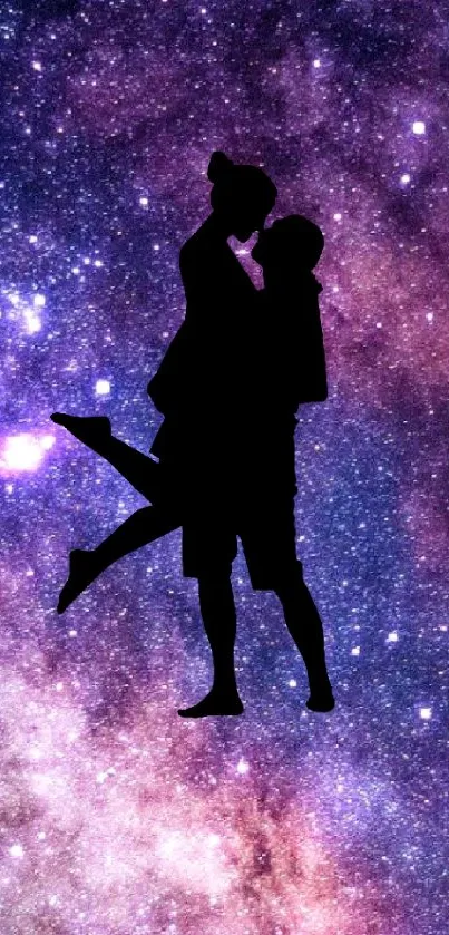 Silhouette of a couple against a vibrant galaxy backdrop with stars.