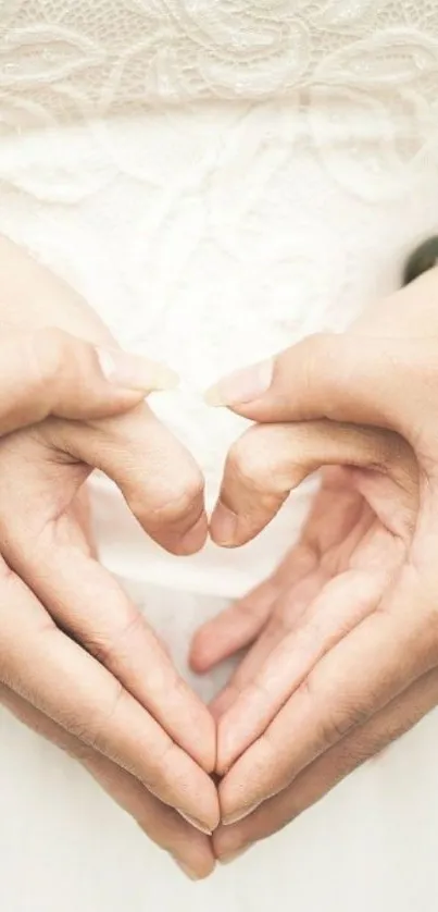 Hands forming a heart in romantic wallpaper.