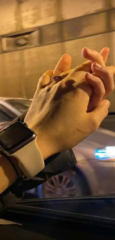 Romantic hands holding in a car with evening ambiance.