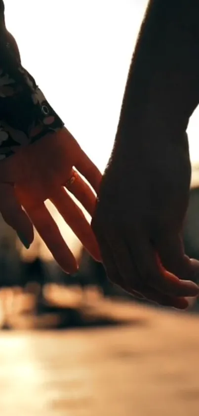 Romantic couple holding hands at sunset, creating a warm and intimate ambiance.