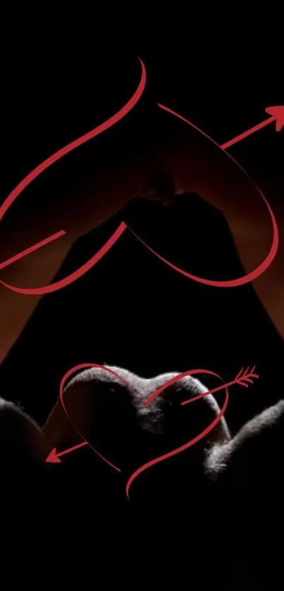 Romantic hands forming a heart with red arrows on dark background.