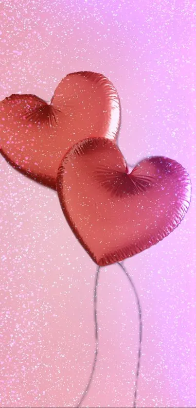 Two pink heart-shaped balloons with glittery background.