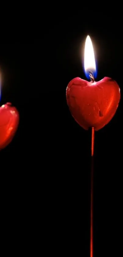 Romantic heart-shaped candle light with warm glow on dark backdrop.