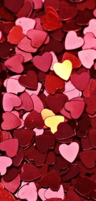 Colorful heart confetti design wallpaper in red, pink, and yellow hues.