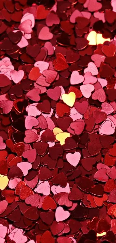 Romantic heart confetti wallpaper in red and pink tones.