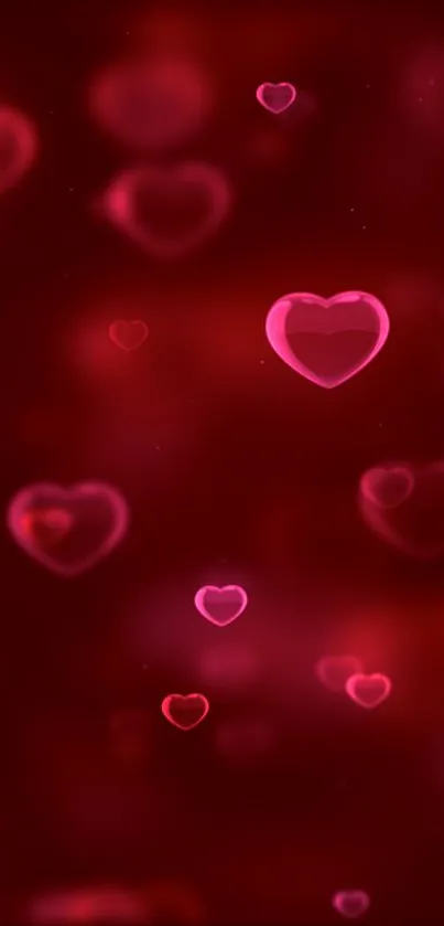 Romantic mobile wallpaper with glowing pink hearts on a red background.