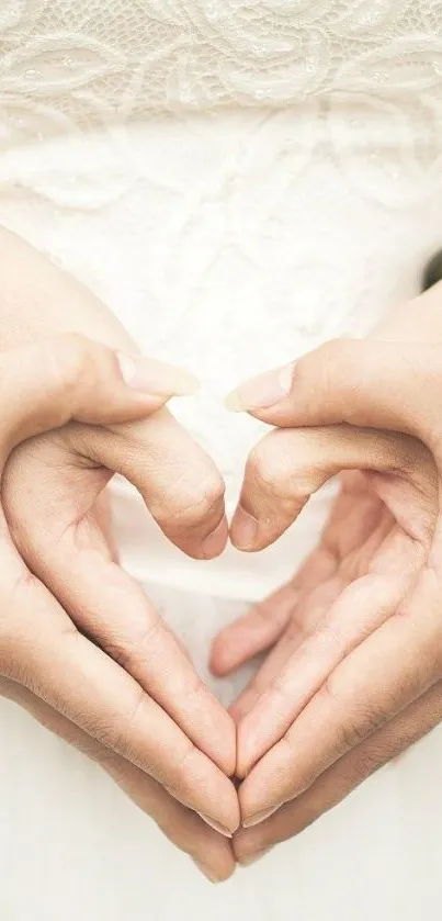 Romantic hand heart gesture on a creamy background.