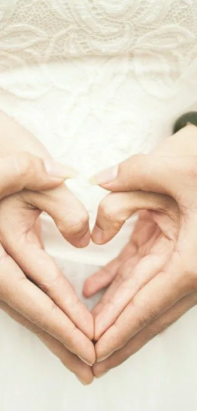 Hands forming a heart on white background.