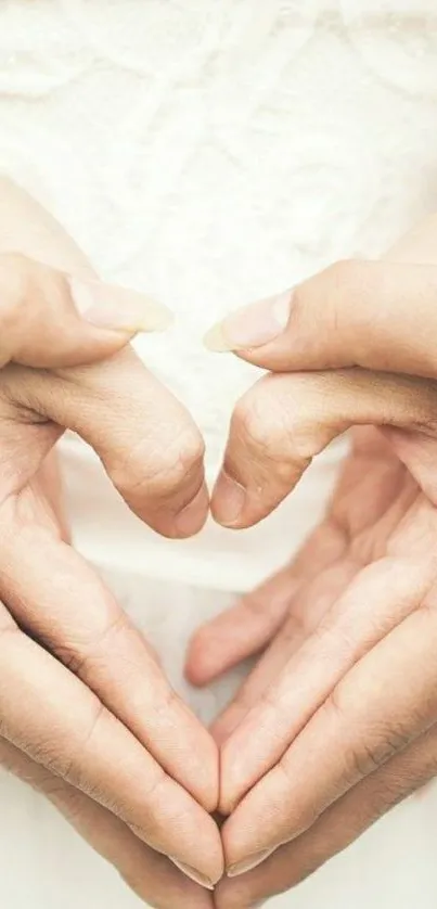 Romantic heart hands forming a heart symbol against a soft background.