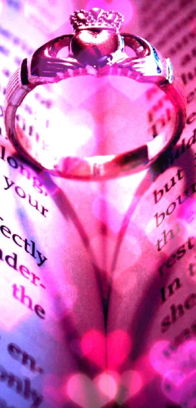 Heart-shaped ring casting shadow on an open pink-lit book.