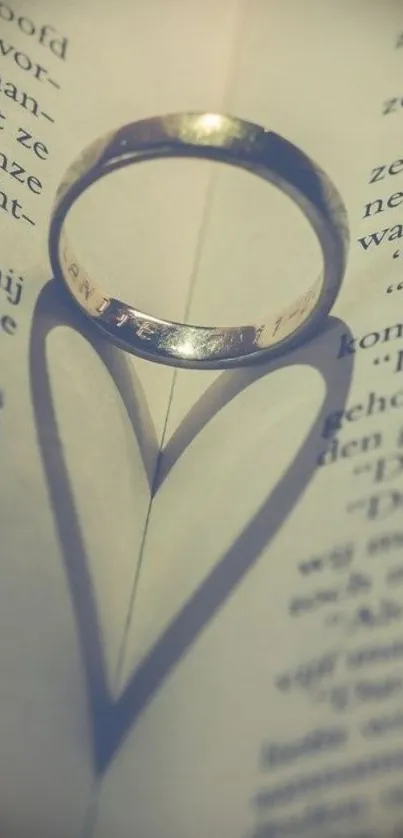 Ring creating a heart-shaped shadow on a book page, evoking romance and elegance.