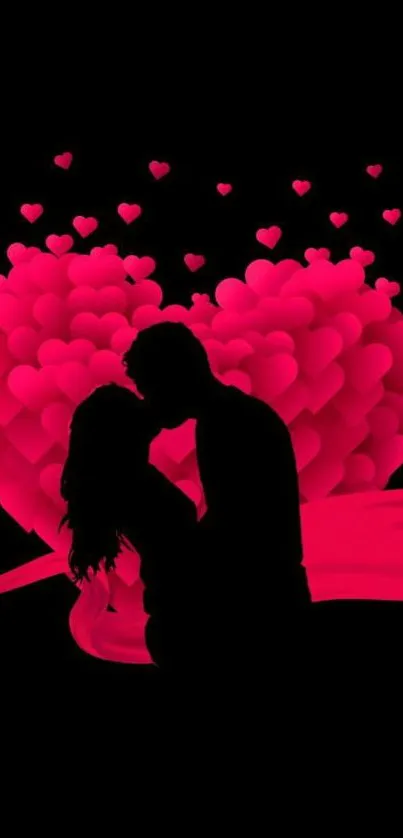 Romantic silhouette of a couple with pink hearts on a black background.